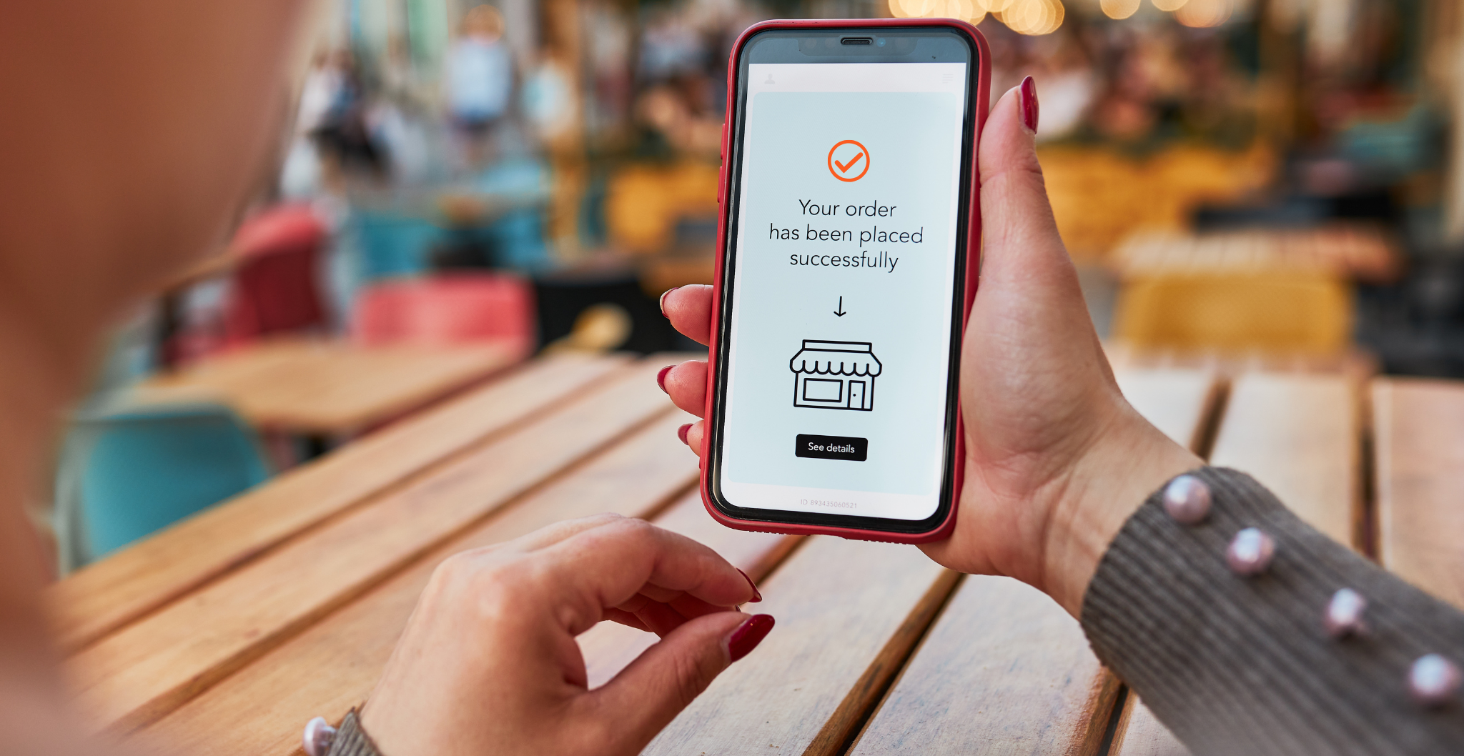 A person holding a phone that displays a successful payment message to convey real-time payments.